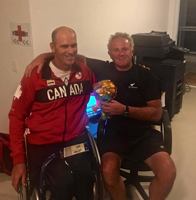 Paul Tingley (CAN) presents Rick Dodson (NZL) with their Bronze medal mascot in recognition of the fact that the two crews tied on points in the Sonar keelboat © SW